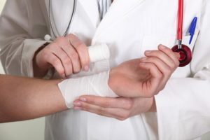 Doctor wraps an injured person's wrist before they call an Accident Lawyer Tulsa, OK